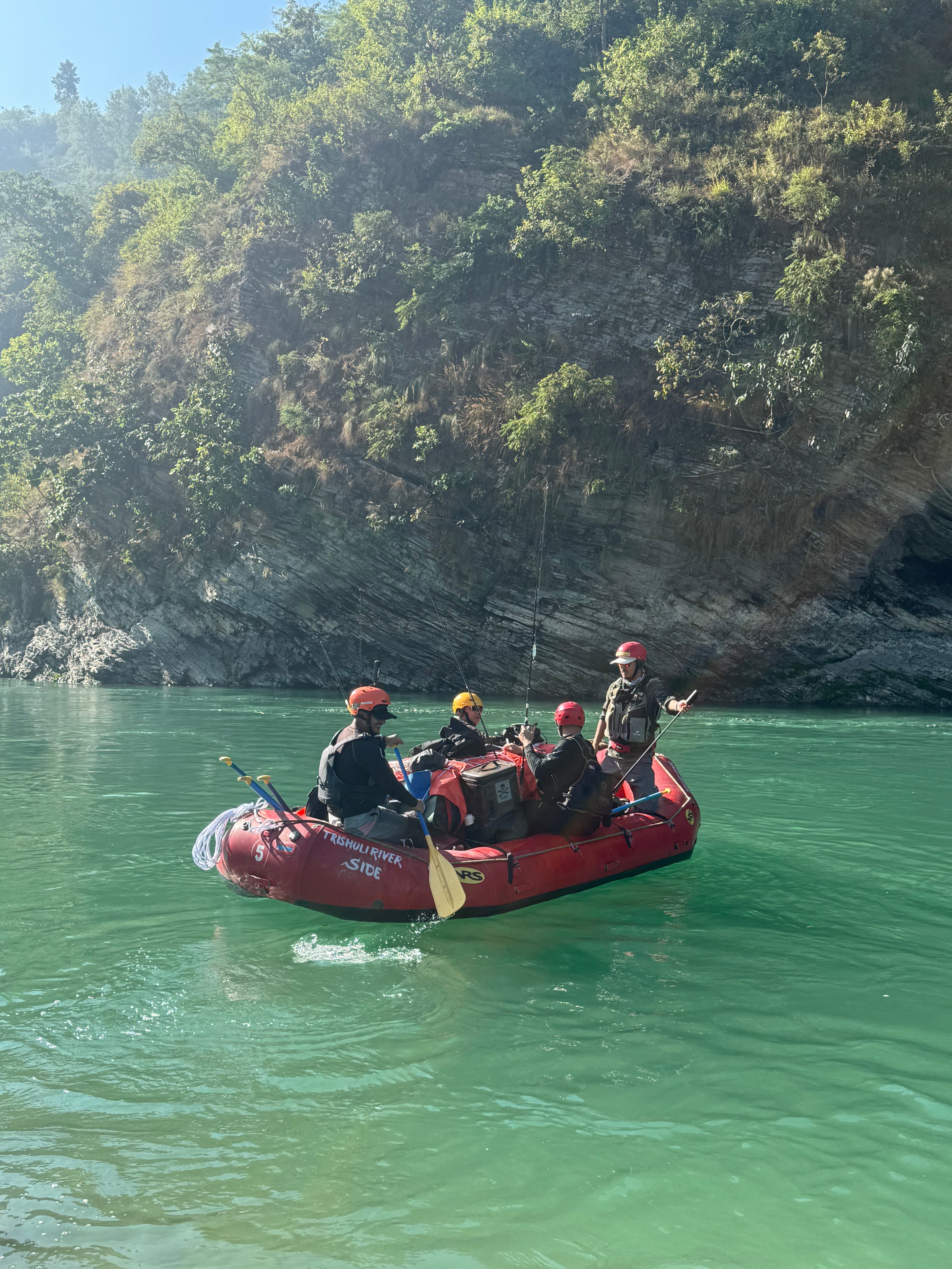 Fishing raft on calm green water